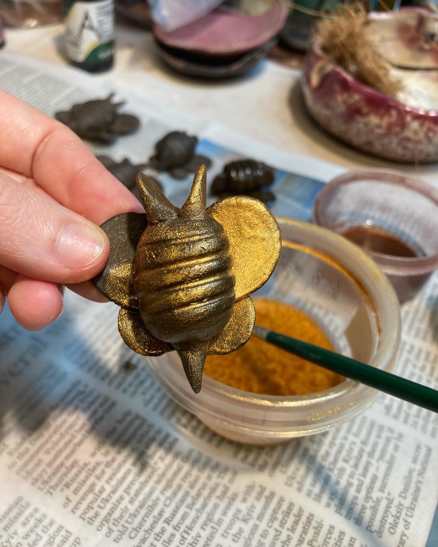 ceramic bee with gold luster by Sienna Mae Heath