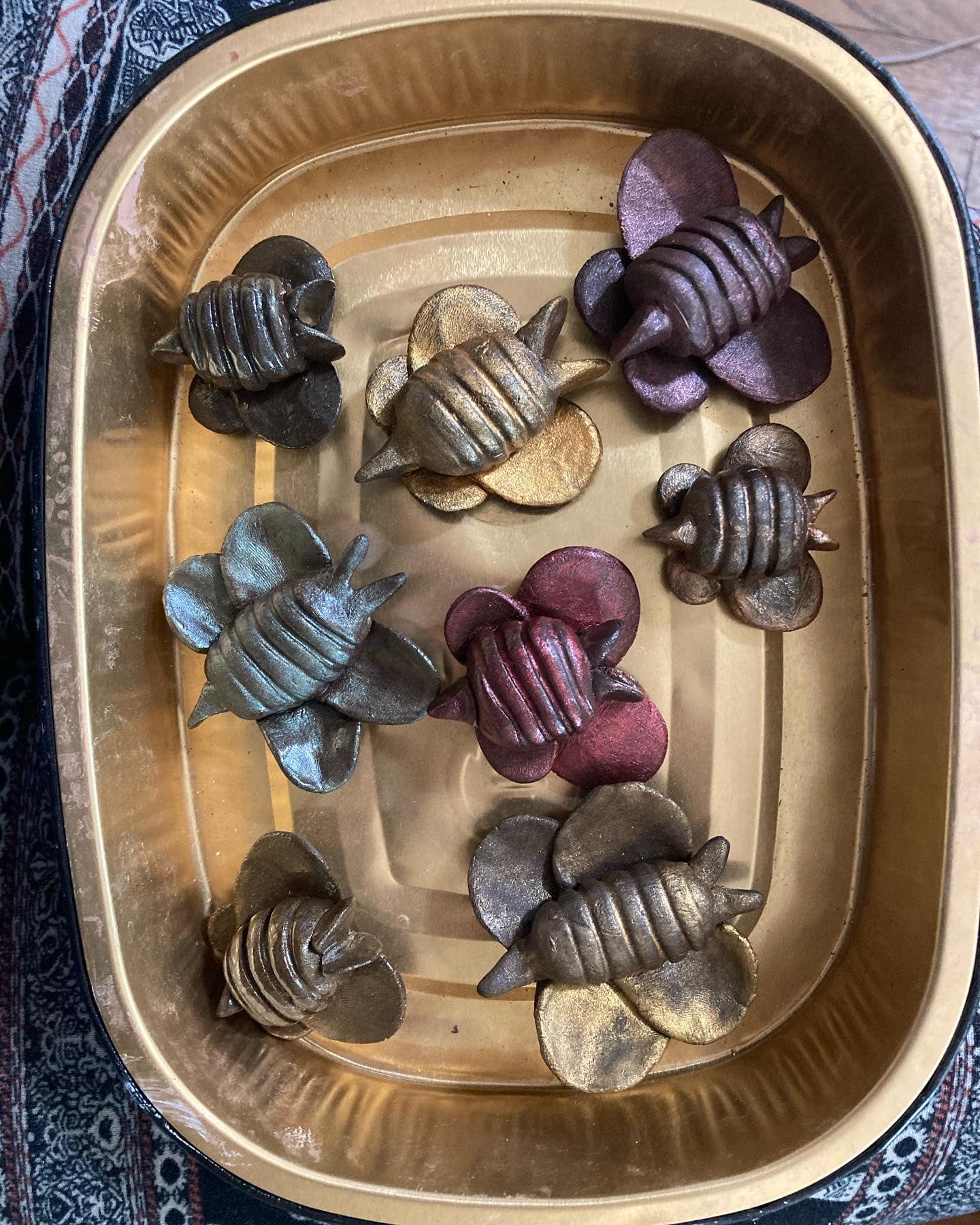 Ceramic bee pins with luster by Sienna Mae Heath