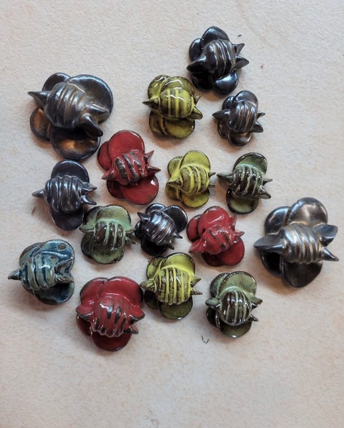 Ceramic bee magnets, cone 6, by Sienna Mae Heath
